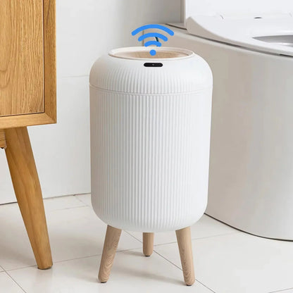 White trash bin with wooden legs in a bathroom setting